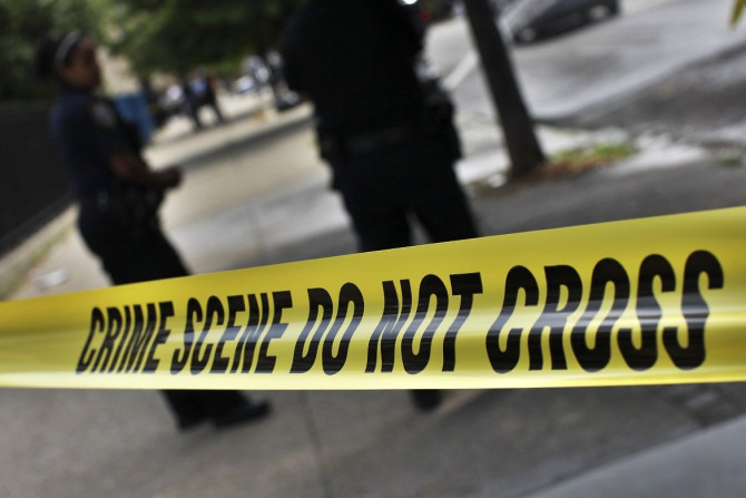 NYPD crime scene tape is seen at the site of a shooting at the corner of Marcus Garvey Blvd. and Pulaski Street in the Brooklyn borough of New York July 9, 2012.