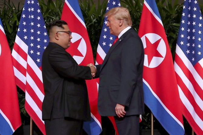 U.S. President Donald Trump shakes hands with North Korean leader Kim Jong Un