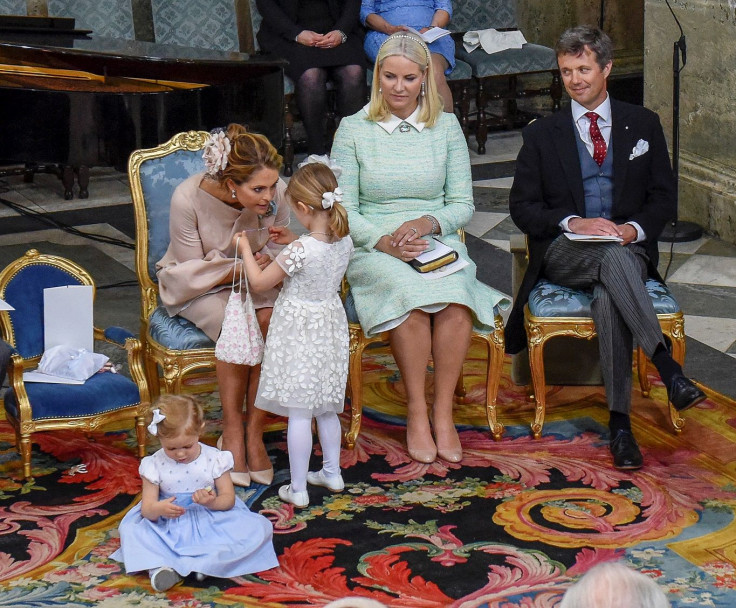 Swedish Princess Madeleine talks to Princesses Estelle and Leonore (seated) while the godparents Crown Princess Mette-Marit of Norway and Crown Prince Frederik