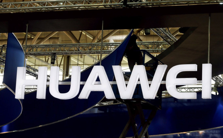 FILE PHOTO: A worker adjusts the logo at the stand of Huawei at the CeBIT trade fair in Hanover, in this file picture taken March 15, 2015.