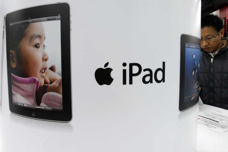 A shopper looks at an Apple Inc iPad at an electronic shop in Tokyo December 27, 2010.