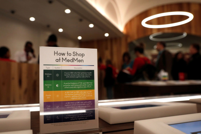 A notice board is seen near customers waiting to purchase products inside MedMen, a California-based cannabis company store 