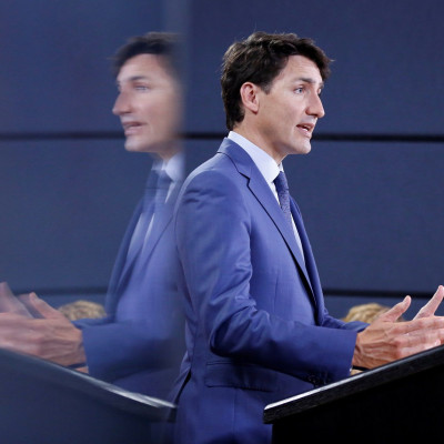 Canada's Prime Minister Justin Trudeau is reflected in a monitor while speaking during a news conference in Ottawa, Ontario, Canada, June 20, 2018.