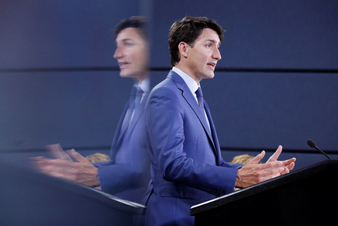 Canada's Prime Minister Justin Trudeau is reflected in a monitor while speaking during a news conference in Ottawa, Ontario, Canada, June 20, 2018.