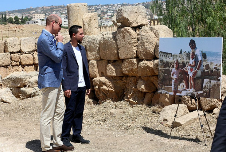 Britain's Prince William and Jordan's Crown Prince Hussein look at a photograph showing William's wife, Catherine, the Duchess of Cambridge, the former Kate Middleton, her father Michael and younger sister Pippa