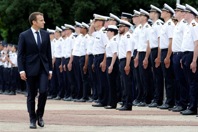 French President Emmanuel Macron walks past members of a French Air Force graduating class during a visit at the 721 Rochefort air base in Saint-Agnant, France, June 14, 2018.