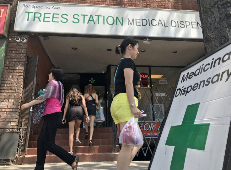 Two women enter the Trees Station, a medical marijuana dispensary, as others walk past in Toronto, Ontario, Canada May 28, 2018. Picture taken May 28, 2018.