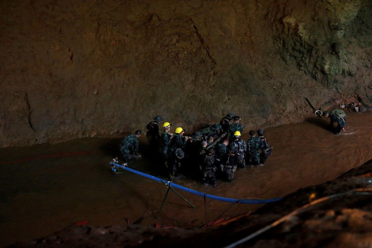 Soldiers and rescue workers work in Tham Luang cave complex,