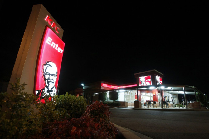 An illuminated sign stands at the entrance to a KFC outlet in the Sydney suburb of Villawood April 27, 2012.