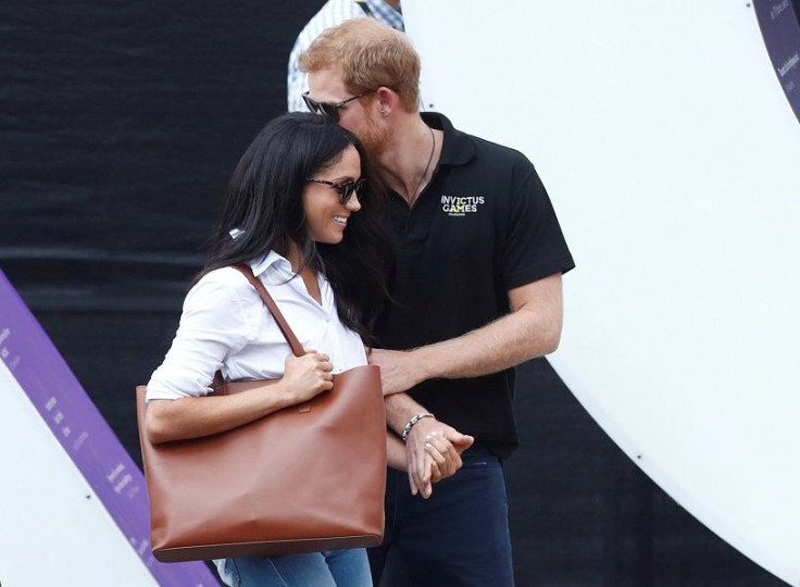 Britain's Prince Harry (R) arrives with girlfriend actress Meghan Markle