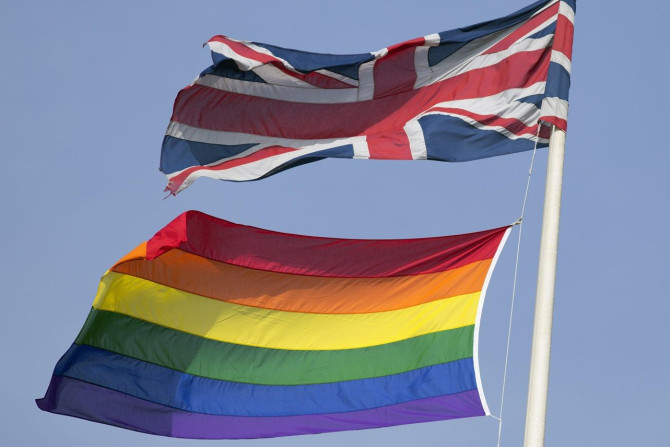 A rainbow flag flies with the Union flag above British Cabinet Offices, marking the first day Britain has allowed same sex marriages, in London March 29, 2014.