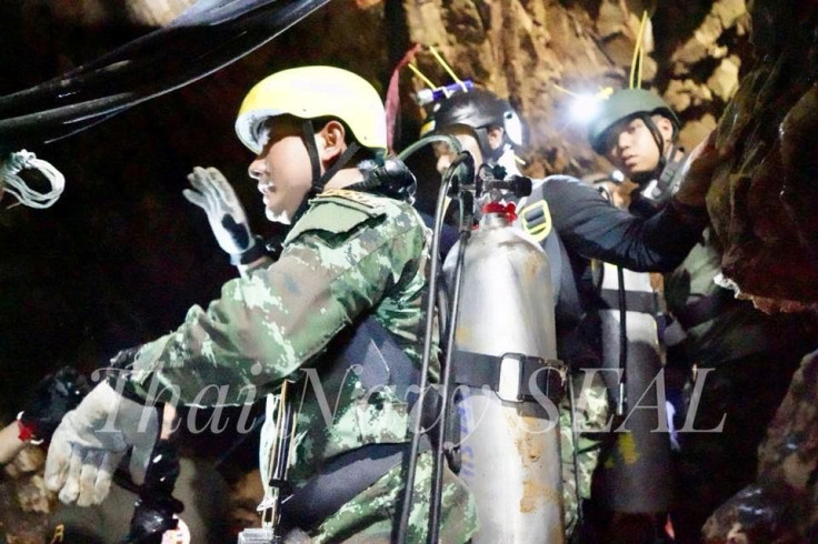 Rescue personnel work at the Tham Luang cave complex, as members of an under-16 soccer team and their coach