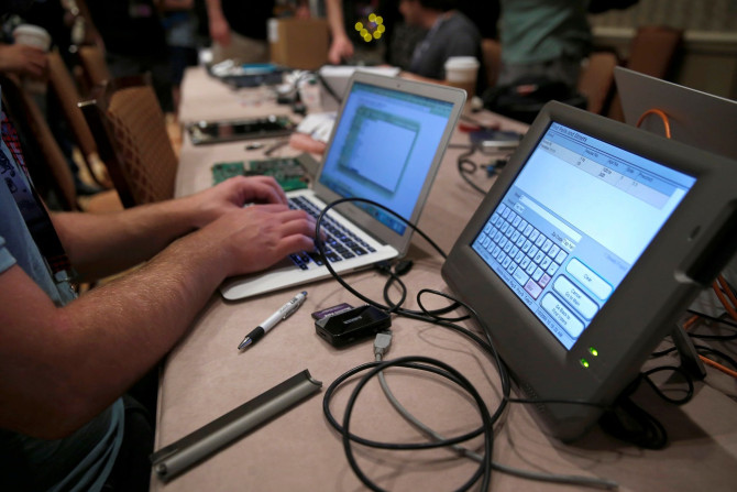 A hacker tries to access and alter data from an electronic poll book in a Voting Machine Hacking Village during the Def Con hacker convention in Las Vegas, Nevada, U.S. on July 29, 2017.