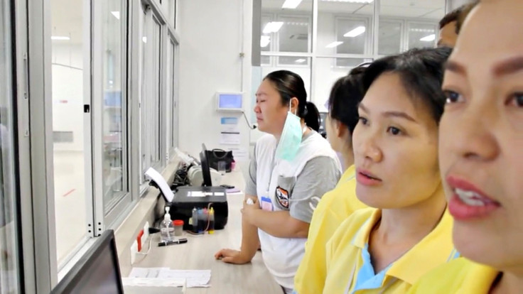 A screen grab shows people looking through glass at the boys rescued from the Thai cave at a hospital in Chiang Rai, Thailand from a July 11, 2018 handout video