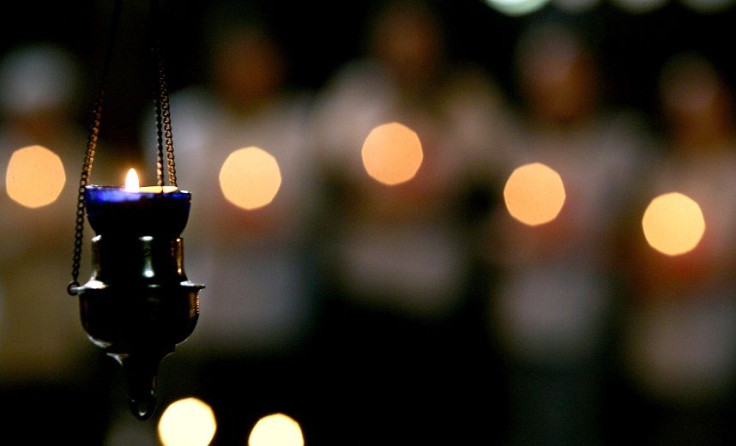 Bulgarian Red Cross volunteers hold candles