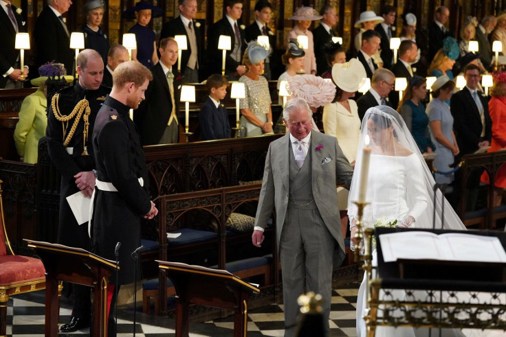 Prince Harry looks at his bride, Meghan Markle, as she arrives accompanied by the Prince of Wales in St George's Chapel at Windsor Castle for their wedding in Windsor, Britain, May 19, 2018.