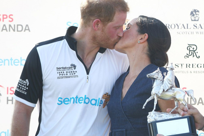 Britain's Prince Harry kisses his wife Meghan the Duchess of Sussex after a charity polo match in Windsor, Britain, July 26, 2018.