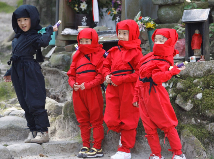 FILE PHOTO: Children dressed as ninjas pose for a souvenir picture during a ninja festival in Iga, about 450 km (280 miles) from Tokyo, April 6, 2008.