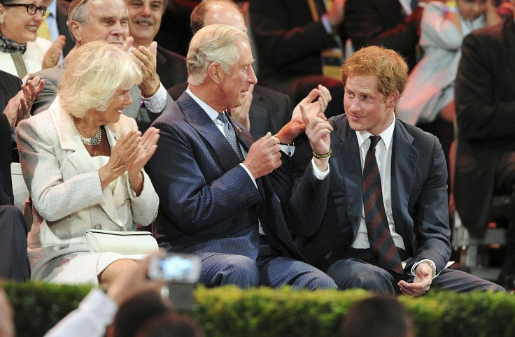 Britain's Camilla, Duchess of Cornwall and Prince Charles applaud Prince Harry (L-R)