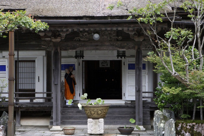 Buddhist monks walk at a temple in Koyasan in Koya, Wakayama prefecture, June 25, 2013.