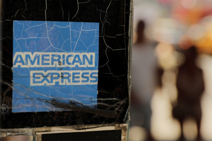 Pedestrians walk past an American Express sign in New York U.S., July 16, 2018.