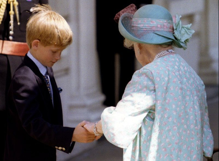 Prince Harry, 10, leads his great grandmother the Queen Mother by the hand as she returns into Clarence House August 4.