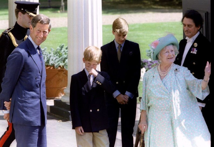 The Queen Mother (2R) waves to crowds outside Clarence House accompanied by her grandson the Prince of Wales (L) and her great grandsons Princes Harry and William.