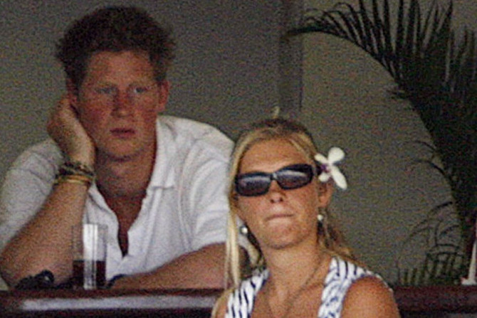 Britain's Prince Harry (L) sits with his girlfriend Chelsy Davy (R)
