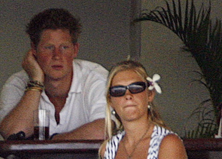 Britain's Prince Harry (L) sits with his girlfriend Chelsy Davy (R)