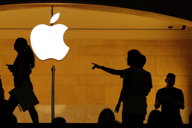Customers walk past an Apple logo inside of an Apple store at Grand Central Station in New York, U.S., August 1, 2018.