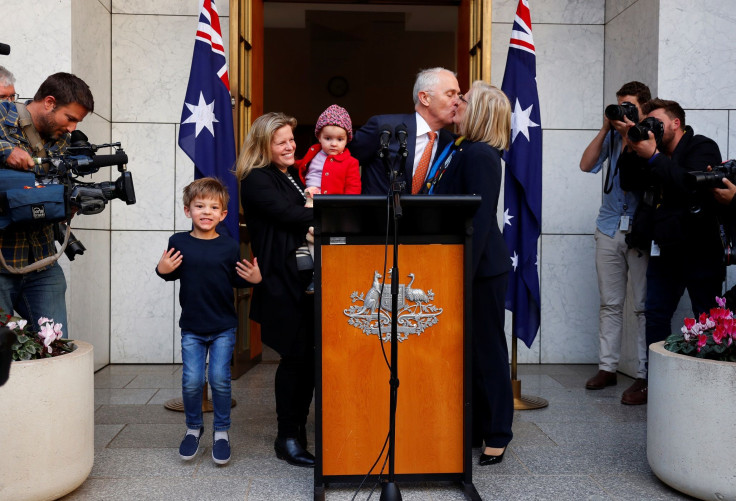 Former Australian prime minister Malcolm Turnbull kisses his wife Lucy, while standing with daughter Daisy, and grandchildren Alice and Jack after a news conference in Canberra, Australia August 24, 2018.