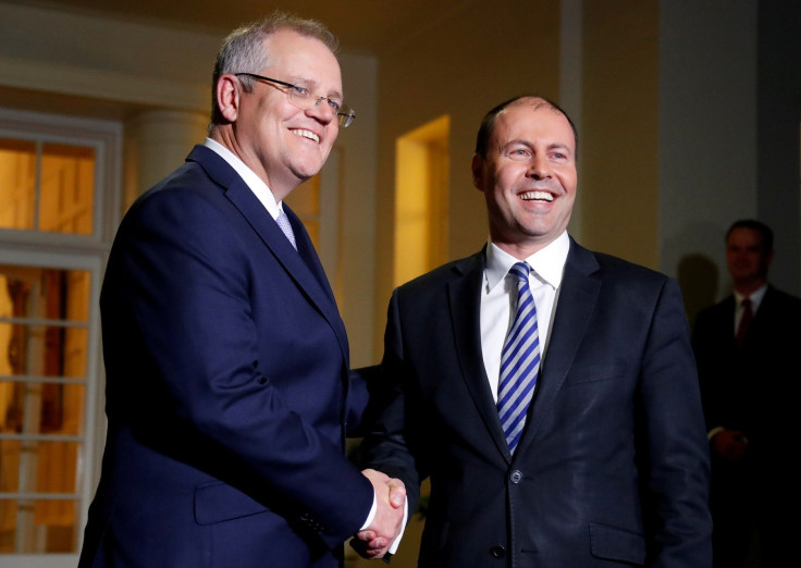 The new Australian Prime Minister Scott Morrison shakes hands with the new Treasurer Josh Frydenberg