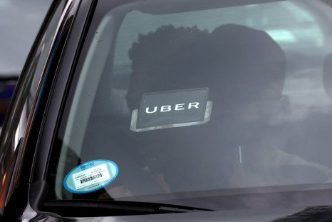 FILE PHOTO: An Uber logo is seen on a car as it car drives through Times Square in New York City, New York, U.S., July 27, 2018. 