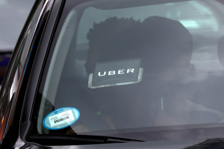 FILE PHOTO: An Uber logo is seen on a car as it car drives through Times Square in New York City, New York, U.S., July 27, 2018.