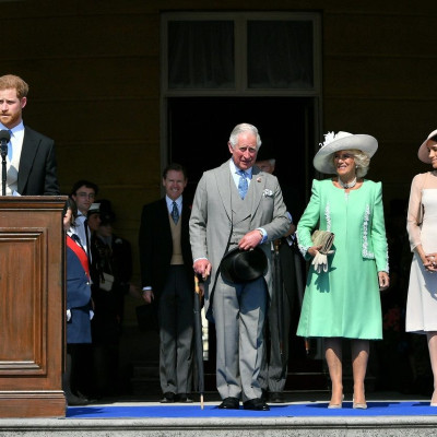 Britain's Prince Harry and his wife Meghan, Duchess of Sussex, at a garden party at Buckingham Palace with Prince Charles and Camilla the Duchess of Cornwall