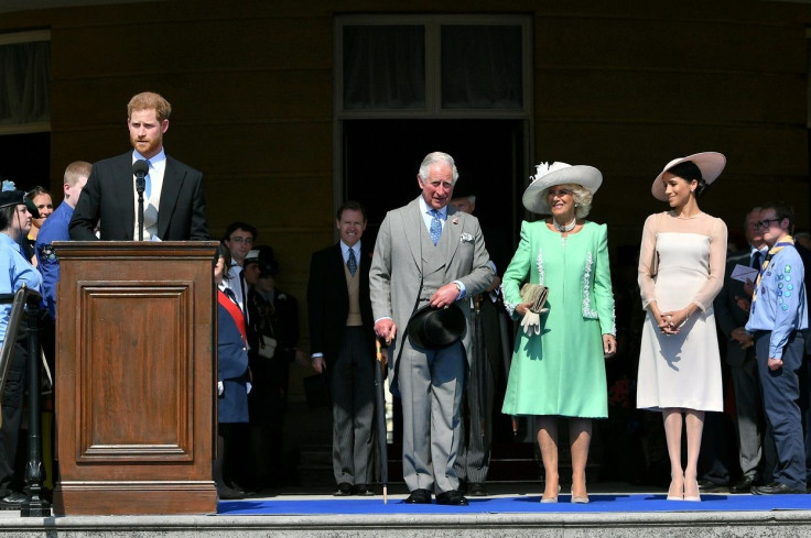 Britain's Prince Harry and his wife Meghan, Duchess of Sussex, at a garden party at Buckingham Palace with Prince Charles and Camilla the Duchess of Cornwall