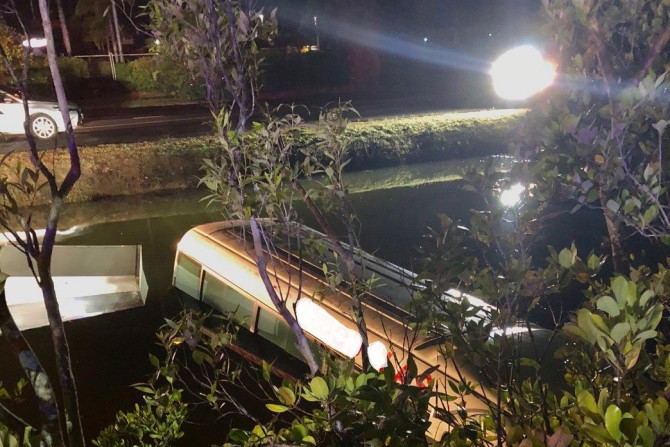 Queensland police dragged a bus driver to safety from a sinking tourist bus in a crocodile-infested creek on Sunday, Sep. 23, 2018.