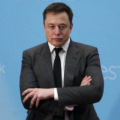 FILE PHOTO: Tesla Chief Executive Elon Musk stands on the podium as he attends a forum on startups in Hong Kong, China January 26, 2016.
