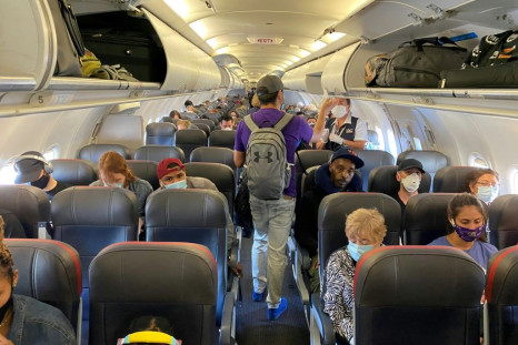 Passengers, all but one wearing masks, board an American Airlines flight from New York to Charlotte, North Carolina, on May 3, 2020