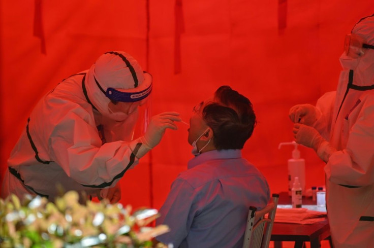 A medical worker takes a swab sample from a man to test for the COVID-19 coronavirus in Wuhan, in Chinaâs central Hubei province