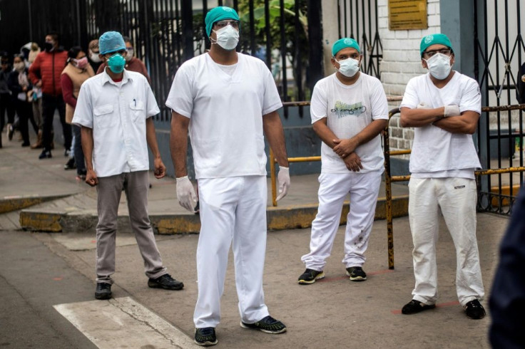 Health workers protest about the lack of protective medical equipment outside the Hipolito Unanue hospital in Lima