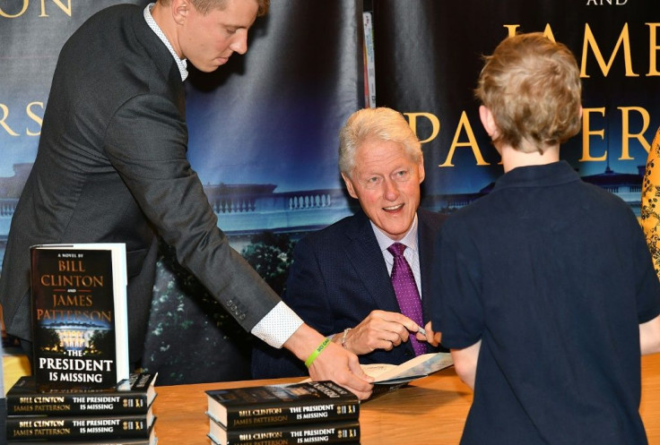 Bill Clinton, shown here in June 2018, signs copies of his first book co-written with James Patterson