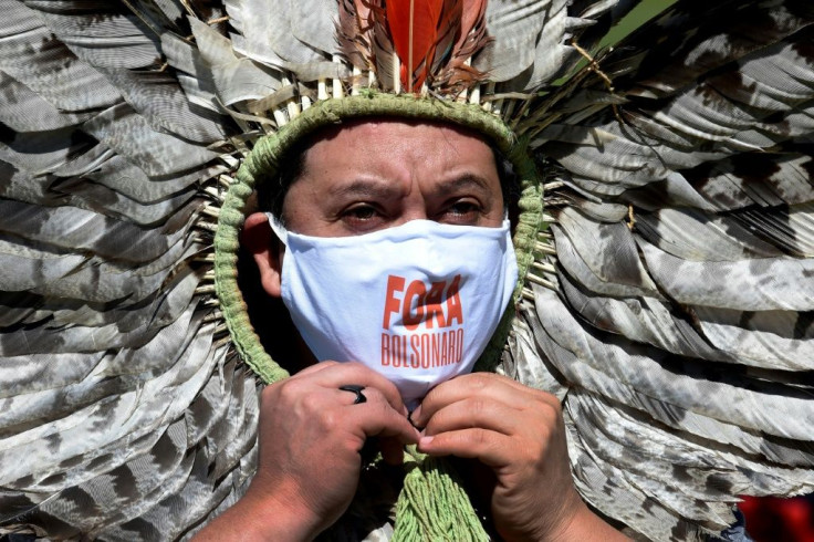 Indigenous Kaingang leader Kretan Kaingang marches in protest against President Jair Bolsonaro as Brazil's COVID-19 death toll reaches new heights