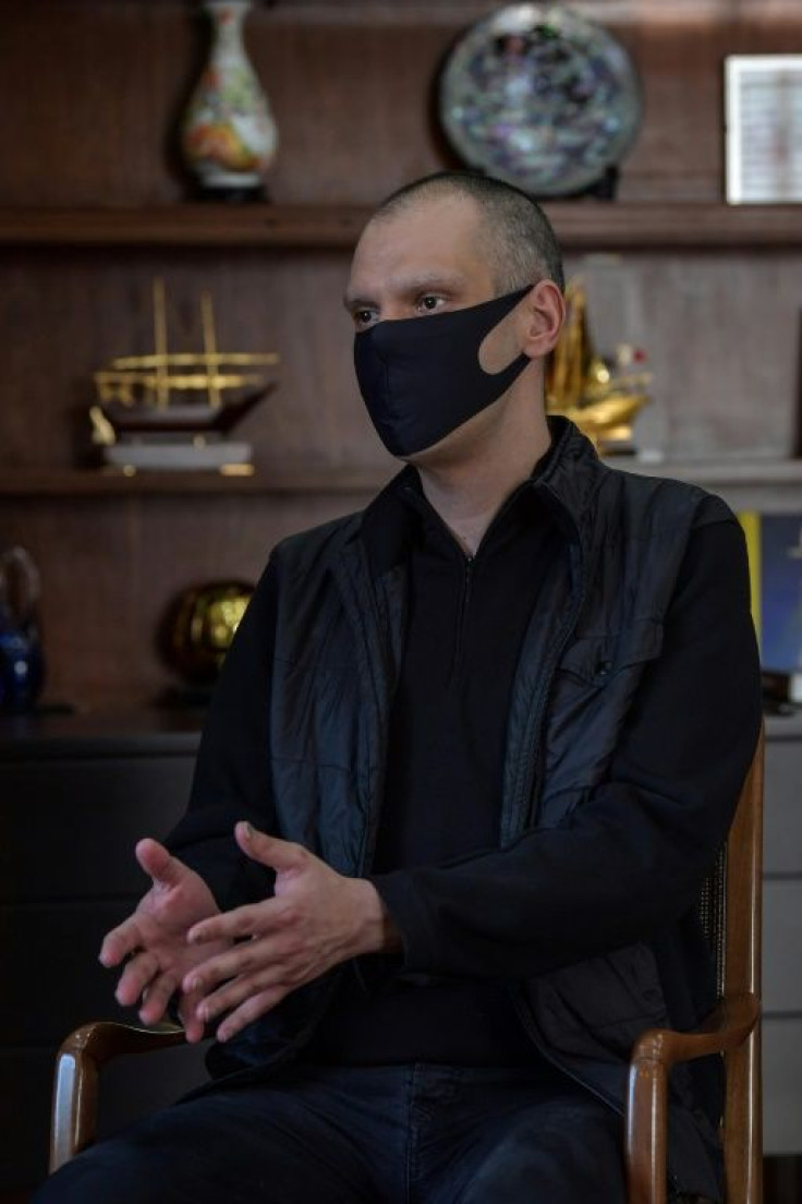 Sao Paulo's Mayor Bruno Covas takes no risks as he dons a face mask as protection during an interview