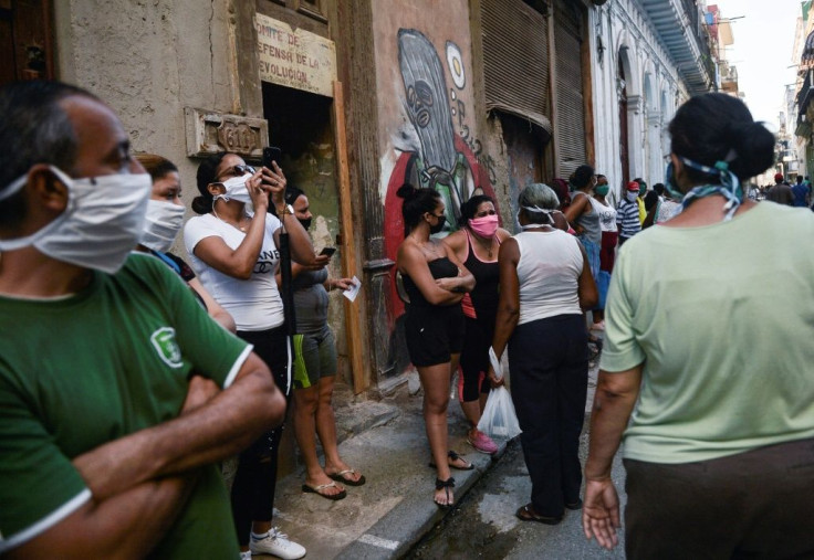 People wear face masks as they queue to buy food in Havana on May 19, 2020, amid the new coronavirus pandemic. US President Donald Trump has ramped up tensions with the island nation after a relaxation during the Obama years