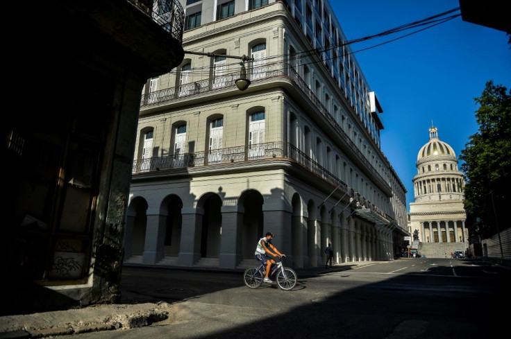 A man rides on his bicycle along an empty street in Havana on May 19, 2020, amid the new coronavirus pandemic. The pandemic has increased pressure on the country which was already suffering food and fuel shortages