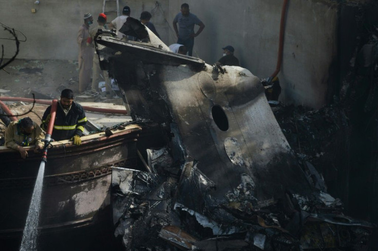 Flames and plumes of smoke were sent into the air as the plane crashed onto a street, its wings slicing through rooftops