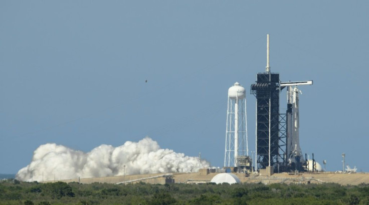 A SpaceX Falcon 9 rocket with the company's Crew Dragon spacecraft onboard at Launch Pad 39A during a brief static fire test on May 22, 2020, ahead of Wednesday's mission -- the first crewed flight from US soil into space since 2011