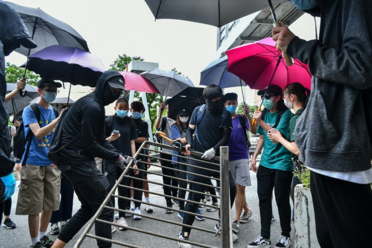 Protesters made makeshift barriers using railings as they clashed with the police