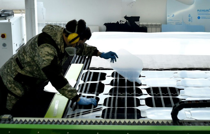 An employee controls the production of protective shields at the Dalisia factory in Minsk